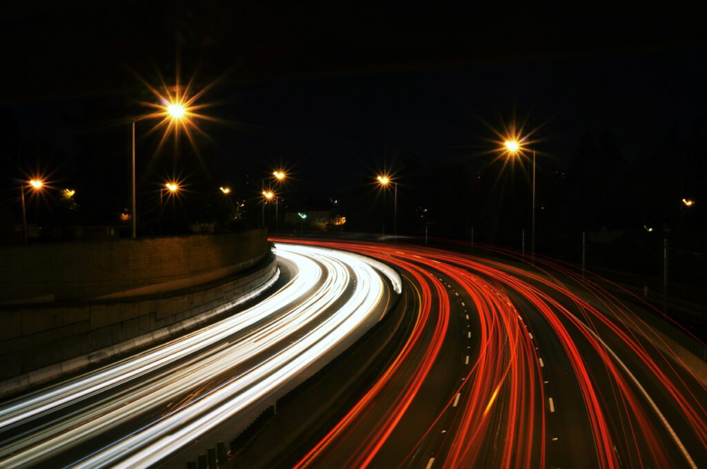 Image of blurred car lights on a dark highway