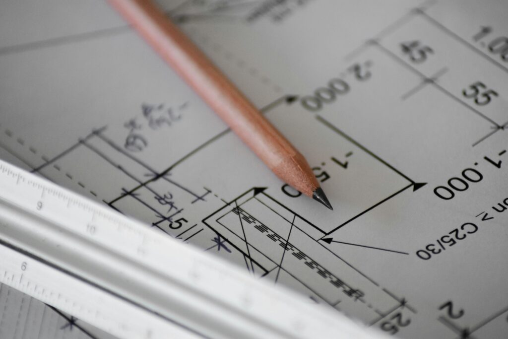 A pencil on a drawn out plan